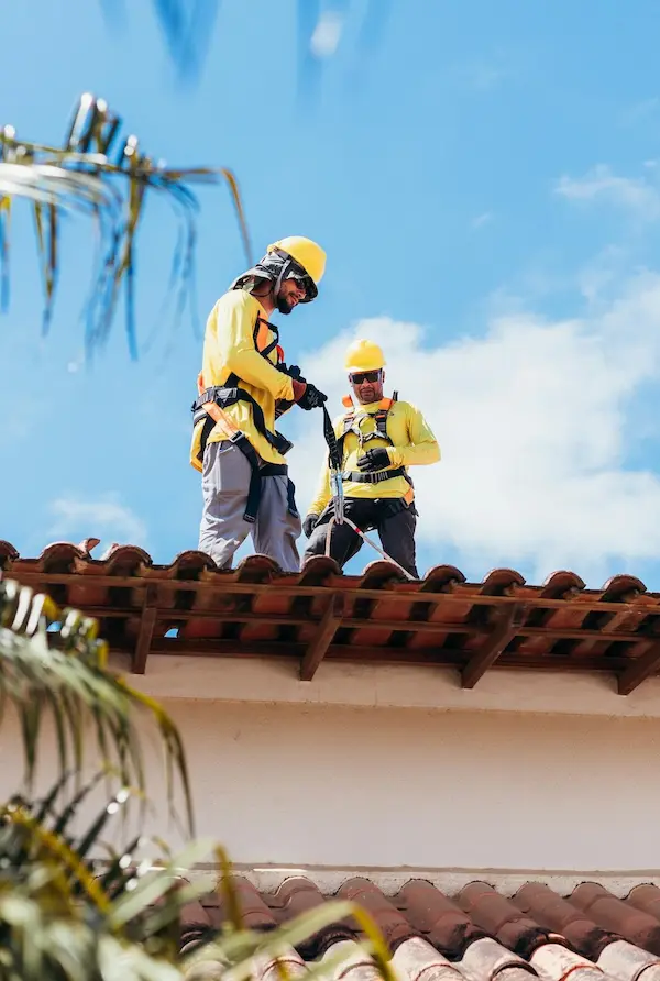 Industrial climbers performing roofing repairs at height